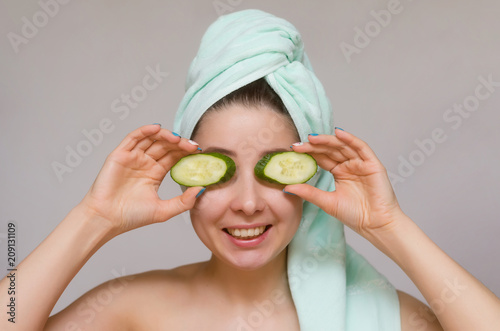 Woman with cucumbers on her eyes. Naturotherapy and face skin care concept.