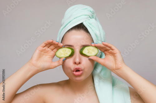 Woman with cucumbers on her eyes. Naturotherapy and face skin care concept.