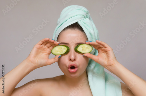 Woman with cucumbers on her eyes. Naturotherapy and face skin care concept.