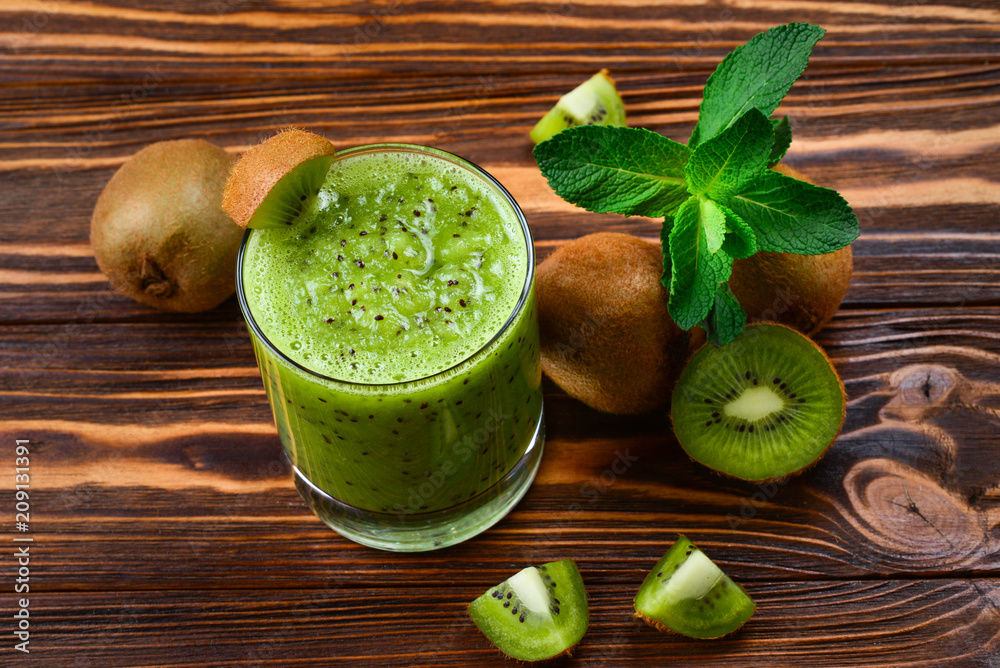 Healthy fresh kiwi smoothie in glass on a wooden background Healthy fresh kiwi smoothie in glass on a wooden background