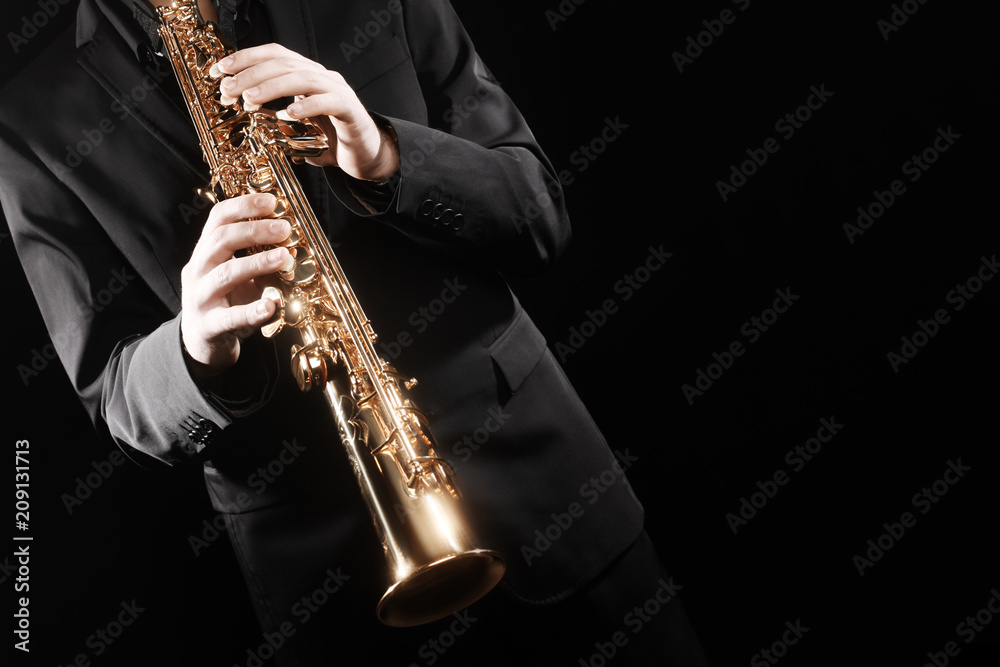 Saxophone player. Saxophonist playing soprano sax jazz music instrument.  Stock Photo | Adobe Stock