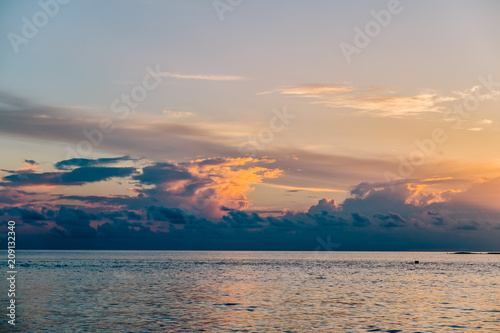 Amazing tropical landscape view. Colorful sky and clouds view with calm sea and relaxing tropical mood. Gorgeous nature background. Maldives  Indian Ocean.