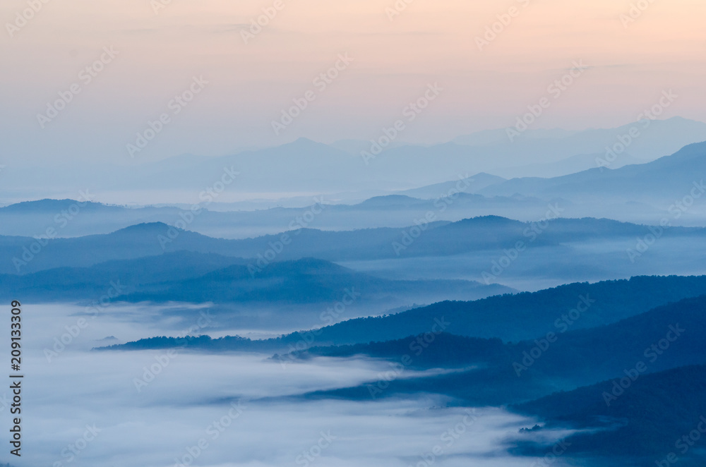 Obraz premium Sunset over mountains and fog. Start the first day of Easter day