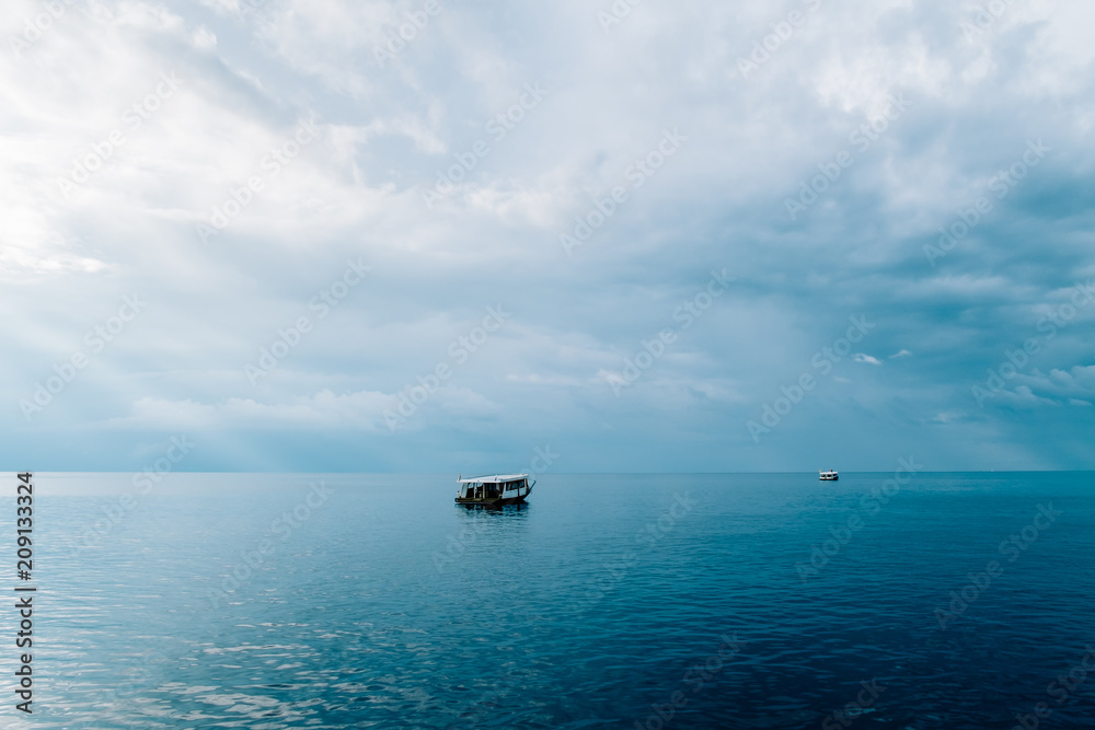 Rasdhoo Atoll, Green blue sea in Maldives with boat