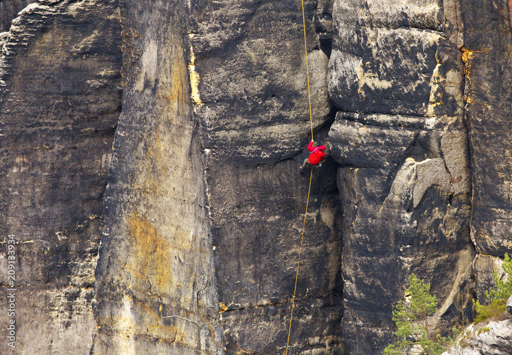 Climber on the rope, Saxony Switzerland, Germany Climber on the rope, Saxony Switzerland, Germany