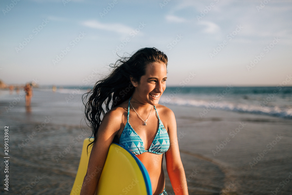 Cute teen girl with a bodyboard at the beach Stock Photo | Adobe Stock