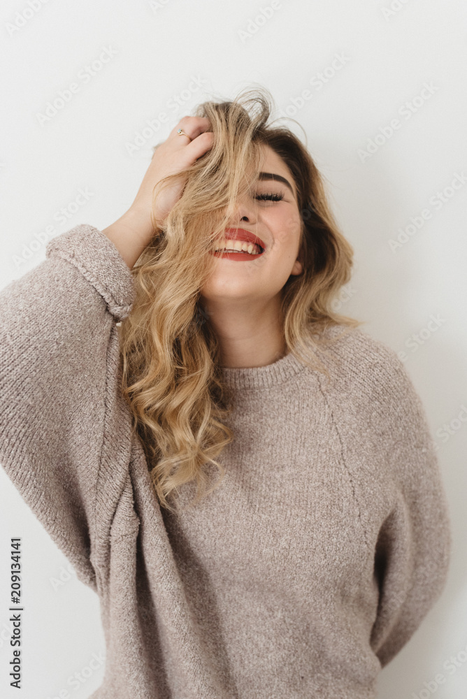 A young woman against a white wall A young woman against a white wall