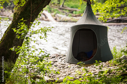 Cacoon hanging tent outside peaceful relaxation photo