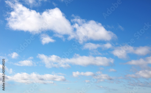 Soft fluffy white clouds in blue sky background