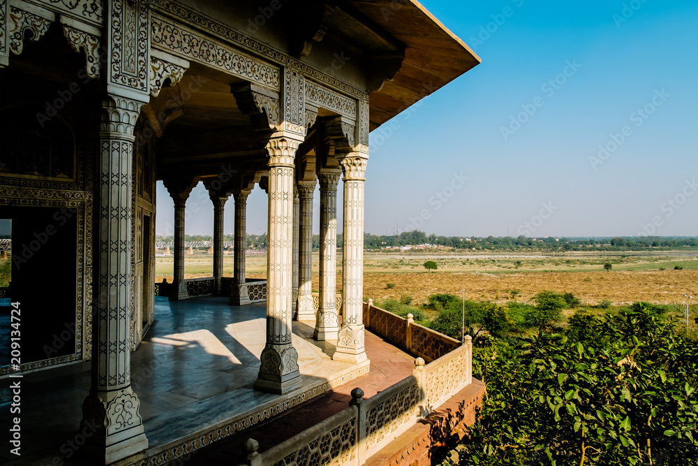 View of Taj Mahal behind Yamuna river from Agra Fort fortress Musamman Burj dome in Agra, India. Agra Fort is UNESCO heritage site in Uttar Pradesh, India.