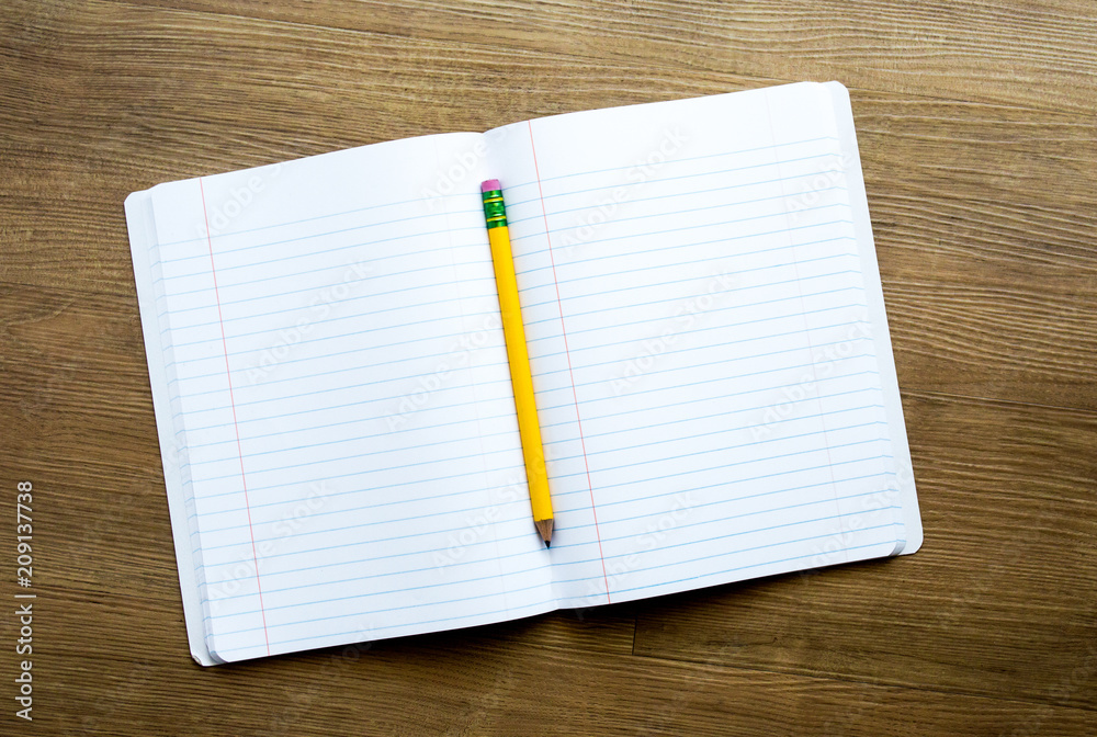 a yellow pencil on top of an open notebook with empty pages for a customized message on a wooden desk a yellow pencil on top of an open notebook with empty pages for a customized message on a wooden desk