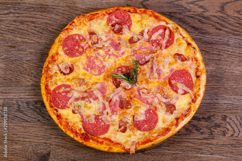 Pizza with ham and sausages