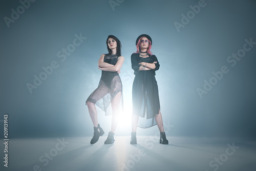 Dancing girls moving in fume and lights 