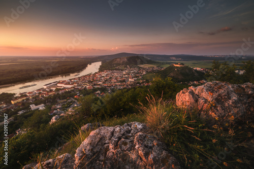 View of Small City of Hainburg an der Donau with Danube River as Seen from Rocky Hundsheimer Hill at Beautiful Sunset photo