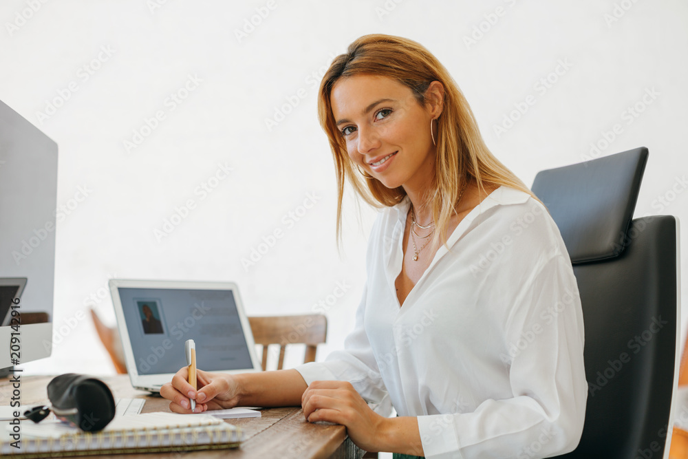 Blonde woman working in a modern office.