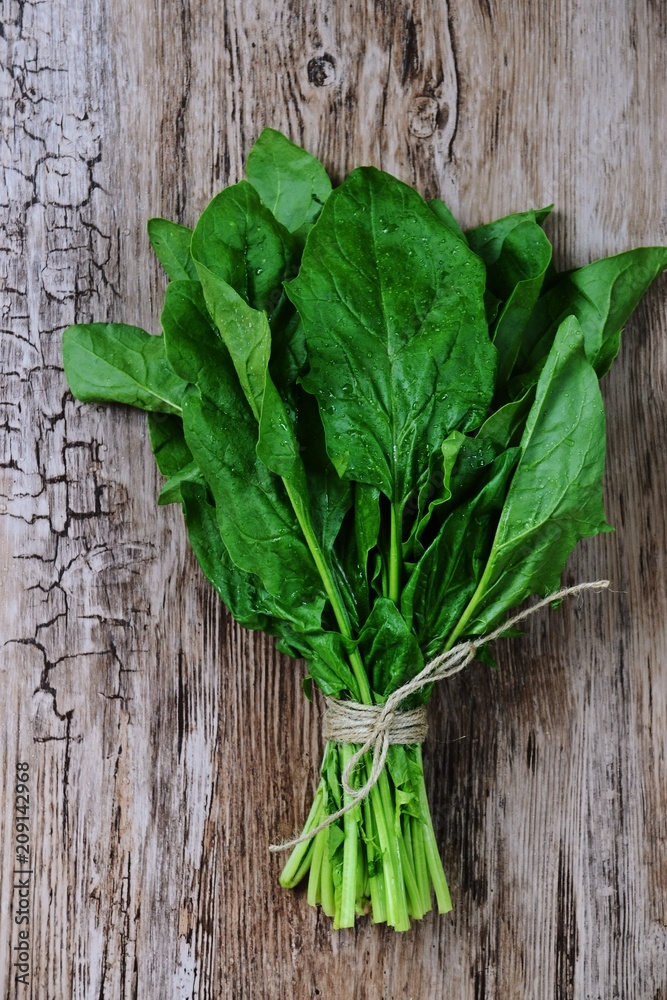 Fresh spinach isolated on wooden background Fresh spinach isolated on wooden background