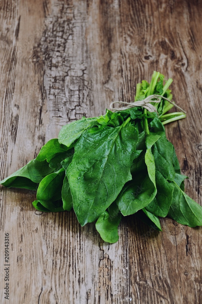 Fresh spinach isolated on wooden background Fresh spinach isolated on wooden background