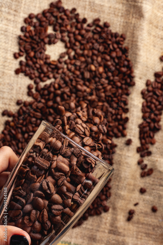 Coffee grains are poured from a glass Coffee grains are poured from a glass