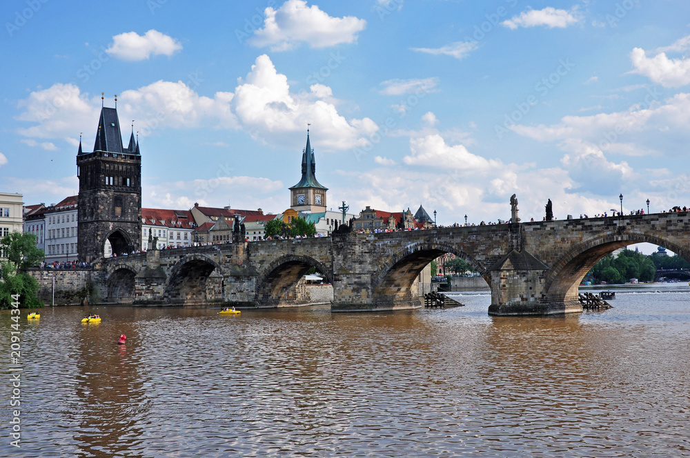 View from the surface of the Vltava River to the historical Gothic Charles Bridge - Prague, Czech Republic. UNESCO monument.