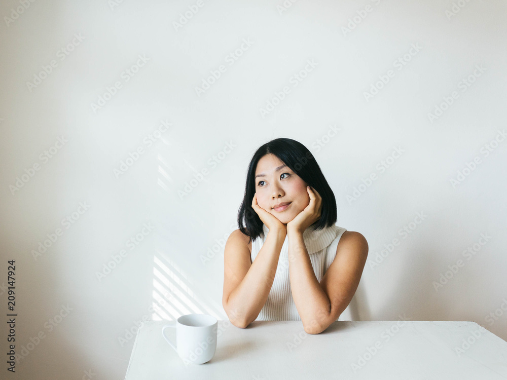 Portrait of young woman looking out the window deep in thought Portrait of young woman looking out the window deep in thought