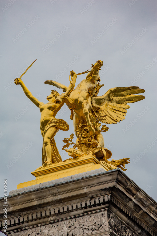 Golden horse and woman with sword statue in Paris France