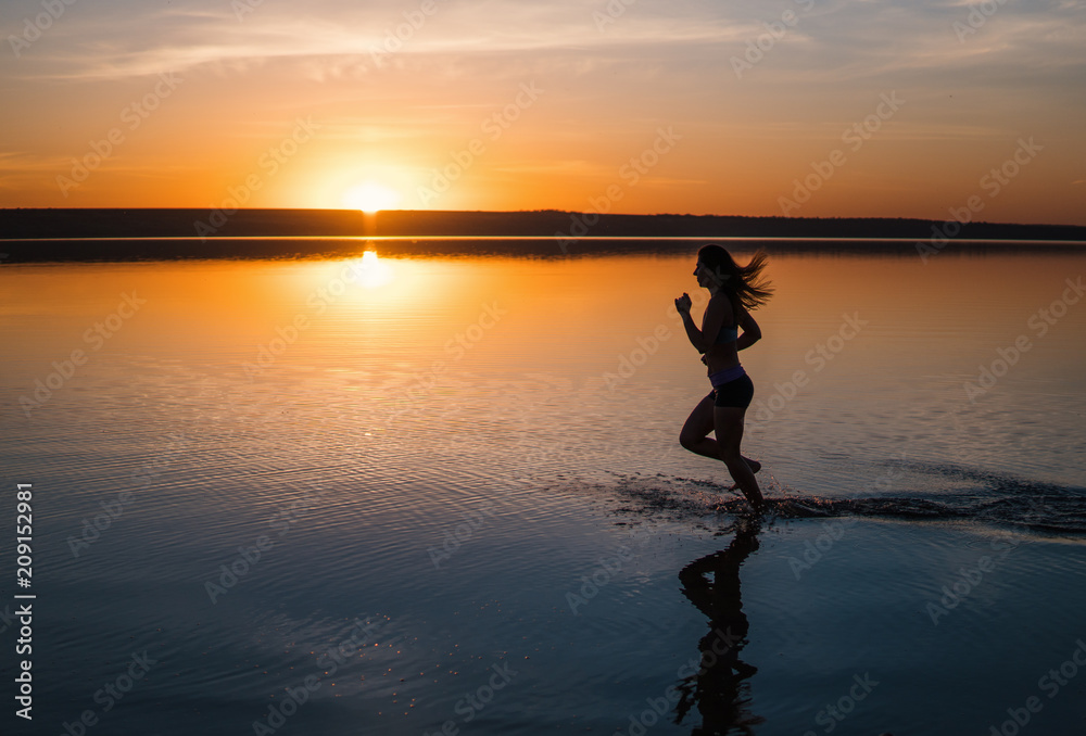 Woman Running on the Beach at Sunset.