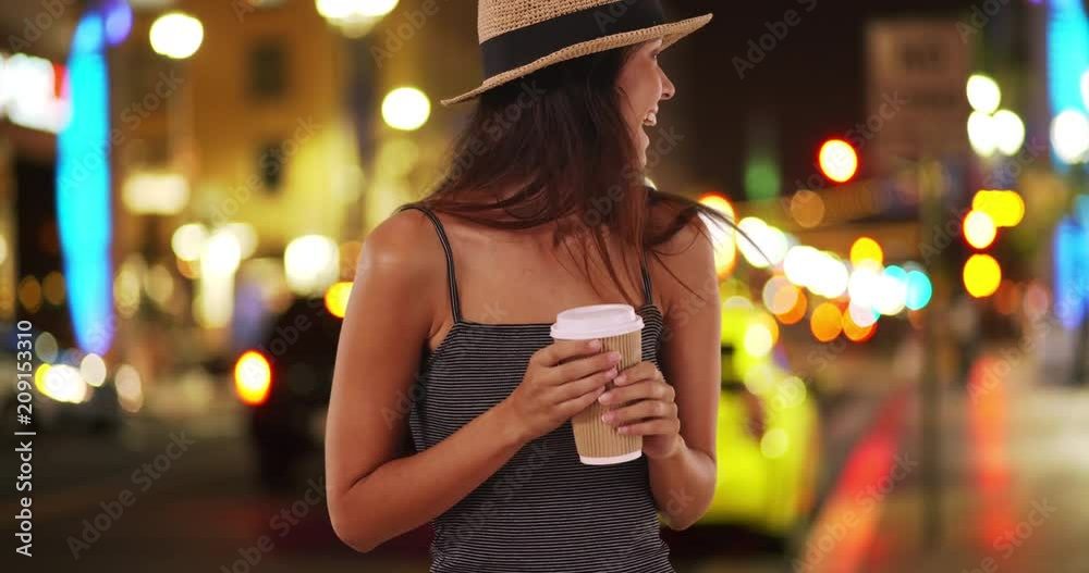 Beautiful Caucasian woman on urban street at night holding cup of coffee, Tourist woman in the city with pretty with bokeh lights enjoying coffee, Cheat for New York, 4k