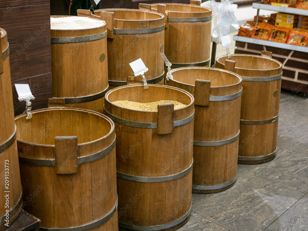 Old wooden barrels with corn, rice and buckwheat in market place Old wooden barrels with corn, rice and buckwheat in market place
