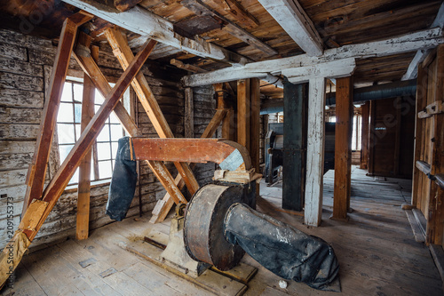 Inside old abandoned wooden mill with old equipment