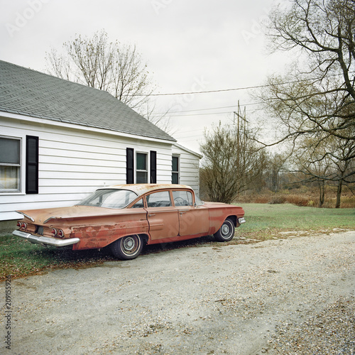 Vintage car by the side of a dirt road photo