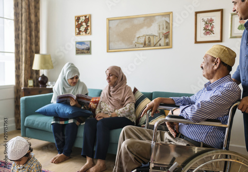 Muslim family relaxing in the home photo