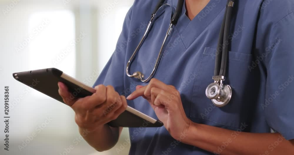 Close up of female nurse or doctor working on table computer inside hospital, Woman medical professional using digital technology, 4k