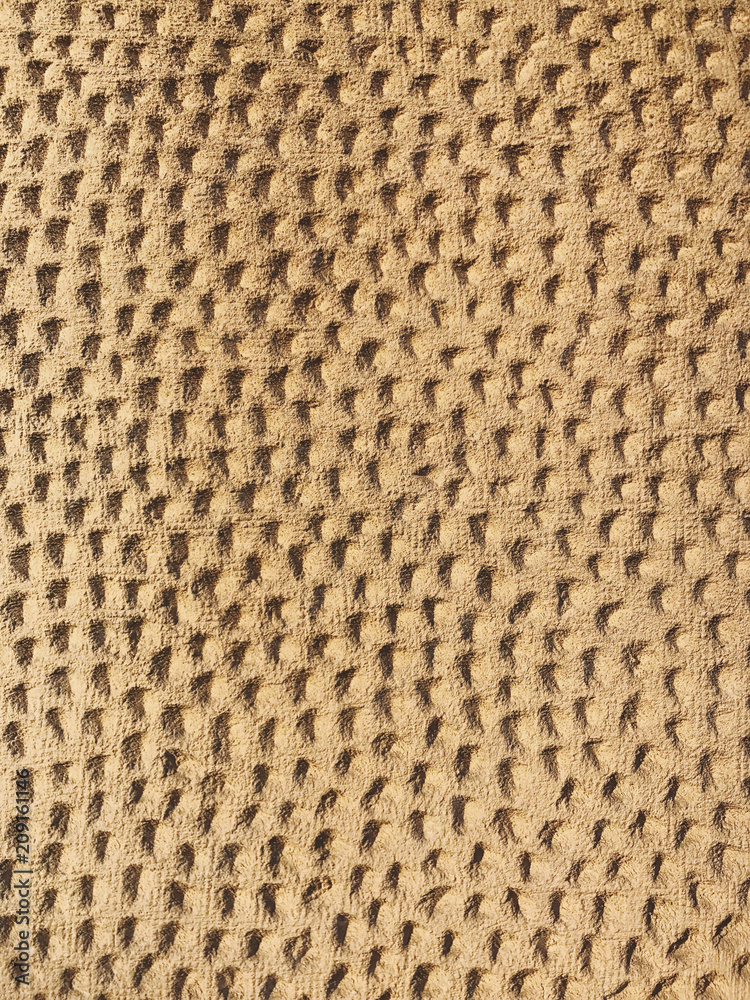 Architectural detail of building wall, small markings on stucco Architectural detail of building wall, small markings on stucco
