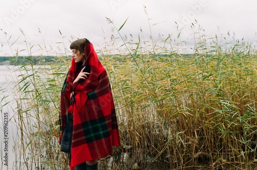 Portrait of young woman covered with  bright wooden plaid photo