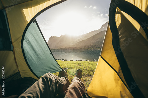 view out of a tent to a mountain lake at sunrise photo