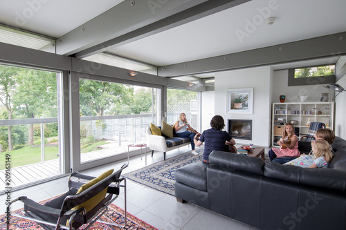 Family relaxing together in their modern living room.