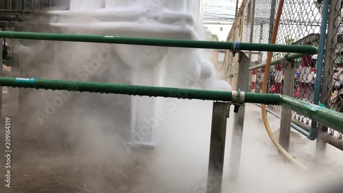 Close up of container with liquid nitrogen,Cold metal pipe smoking from transferring liquid nitrogen 