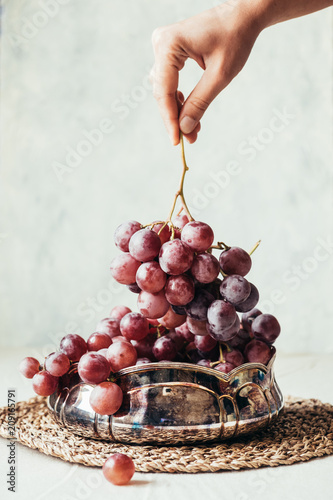 Hand holding fresh juicy grape photo