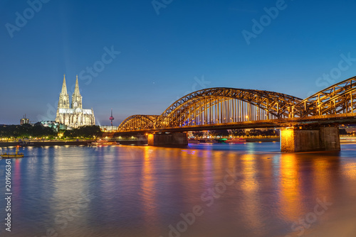 The famous Cologne Cathedral and the Hohenzollern railway bridge at night © elxeneize