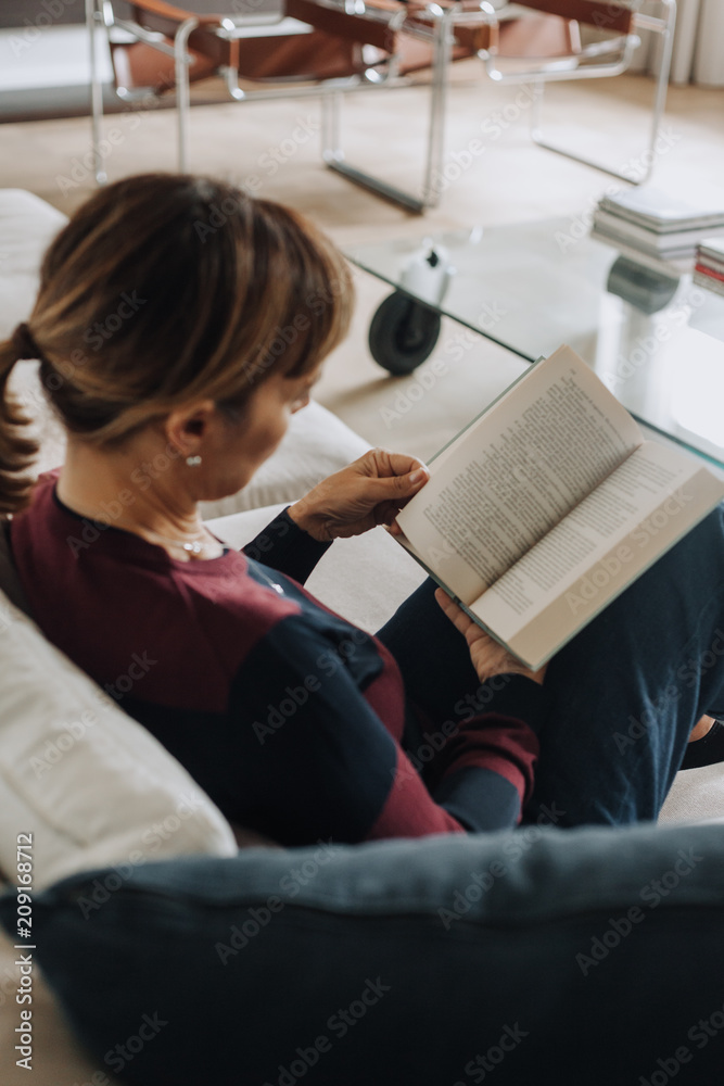 Woman reading on the couch Woman reading on the couch