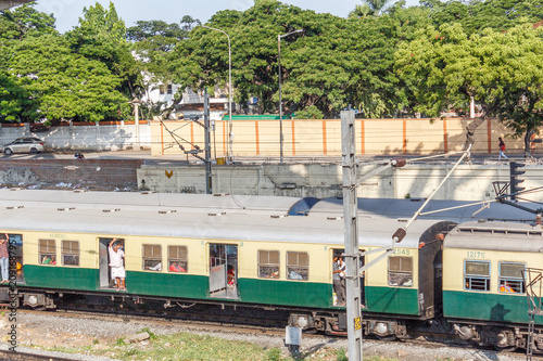 Chennai india may 27 2018 people seen travelling in local electric train towards marina beach station. Location is guindy railway station. people seen footboarding in the train which is risky at times photo