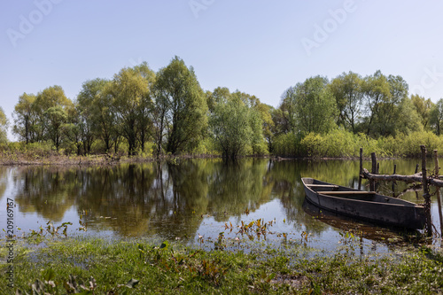 Wooden boat at village places in the floodplain forests of the Desna river, Ukraine. Landscape view