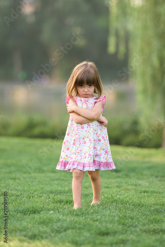 Portrait of miffed cute girl looking at camera photo