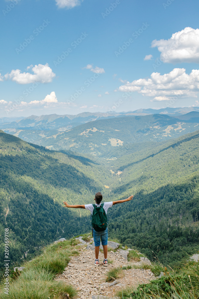 Young man with backpack enjoying beautiful landscaped nature. Young man with backpack enjoying beautiful landscaped nature.