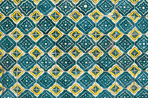 Mexican ceramic mosaic wall, green tile background texture.
