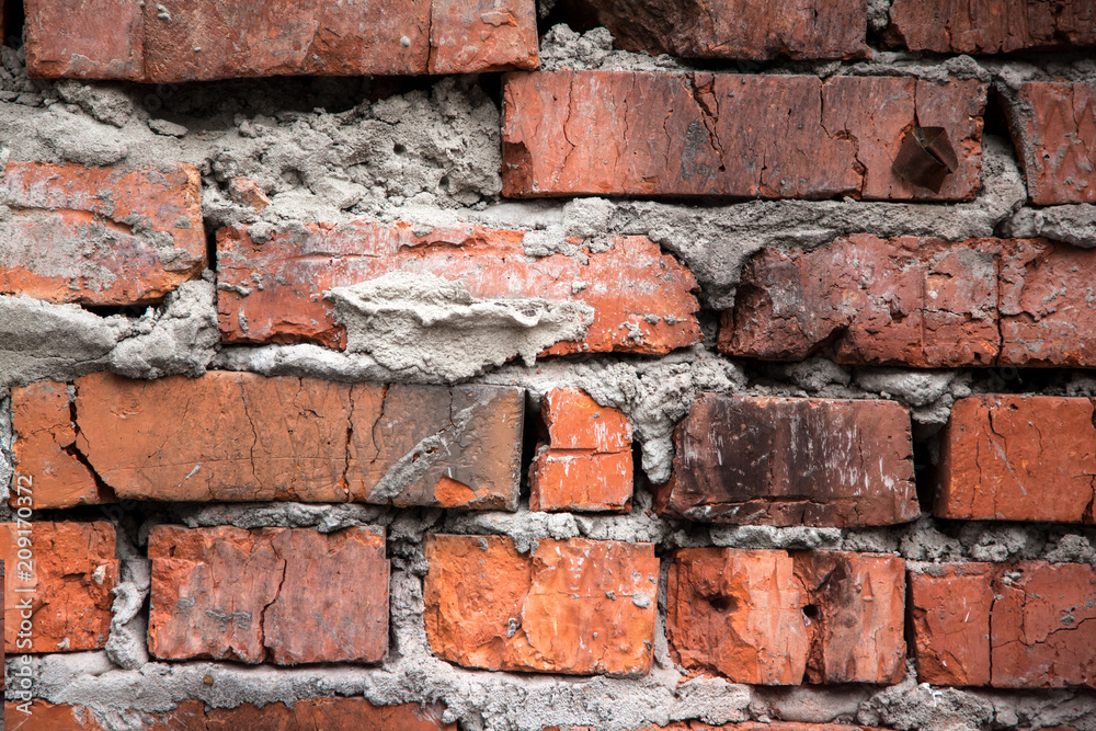 Red brick old wall with blackened bricks, texture grunge background Red brick old wall with blackened bricks, texture grunge background