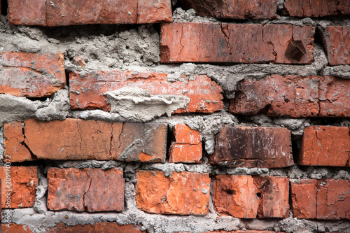 Red brick old wall with blackened bricks, texture grunge background