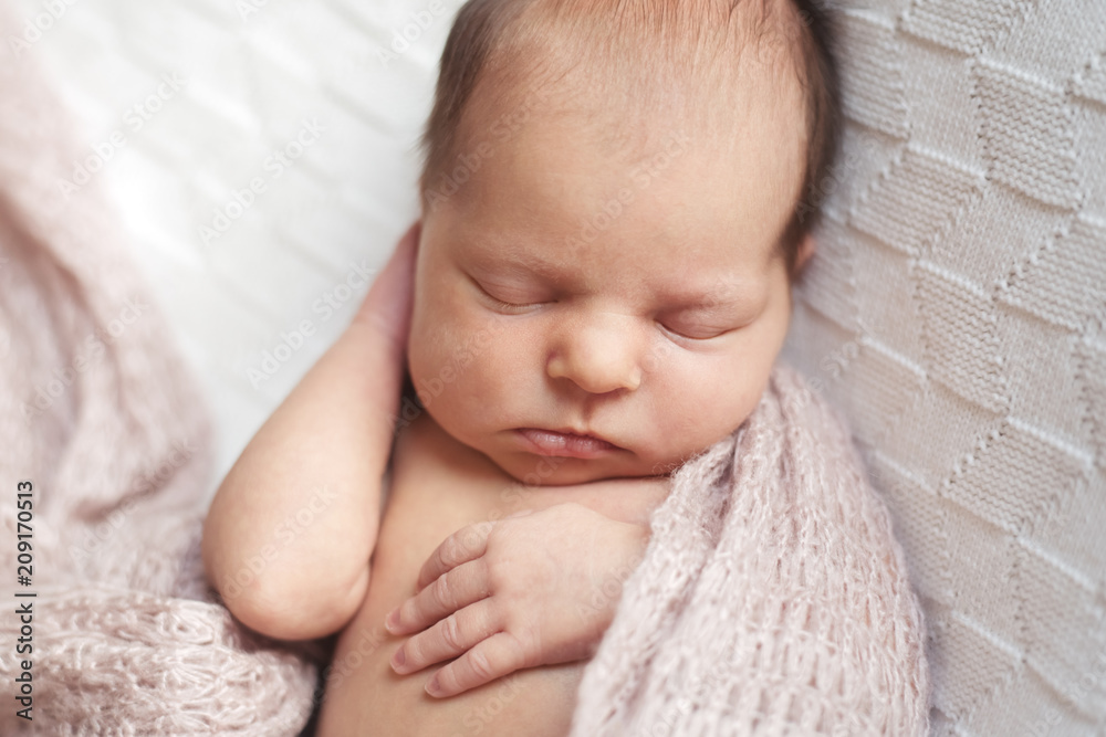 Gorgeous baby sleeping wrapped up in a knit blanket Gorgeous baby sleeping wrapped up in a knit blanket
