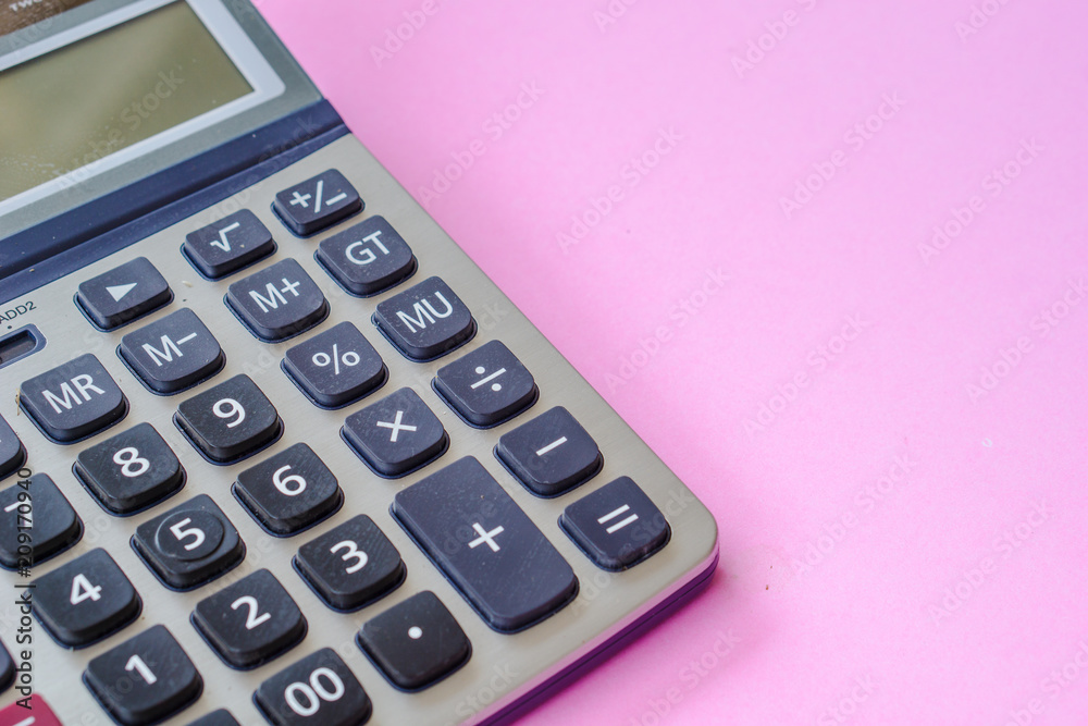 Closeup calculator on the working pink table Closeup calculator on the working pink table