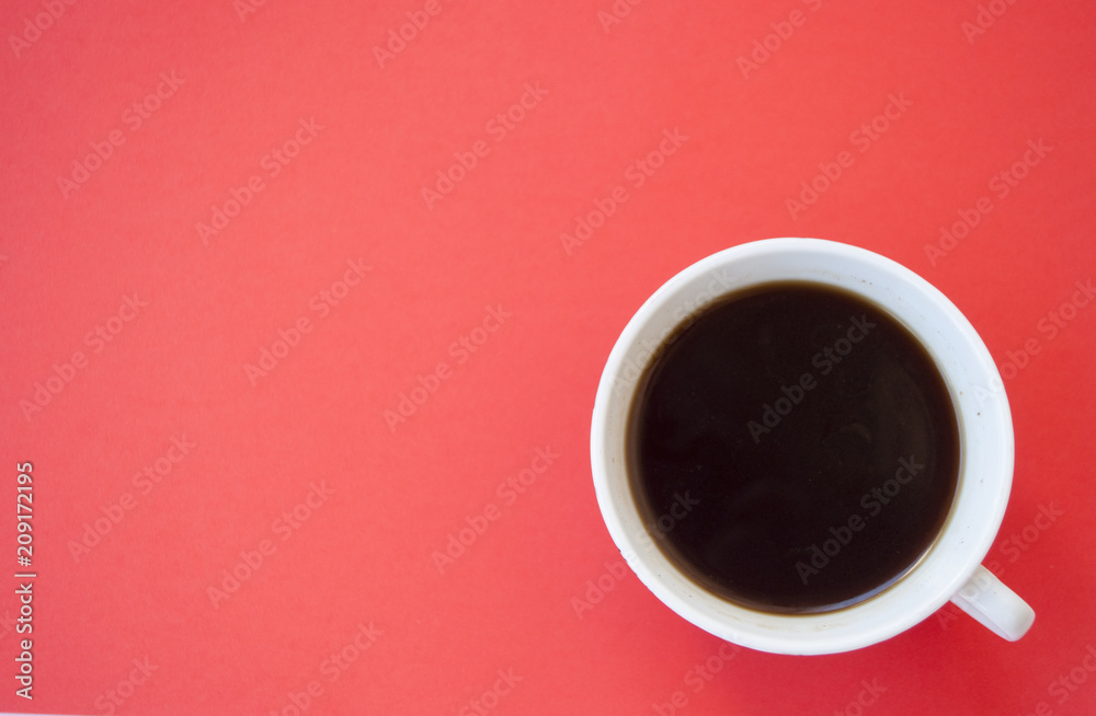 A cup of coffee on red background. A cup of coffee on red background.